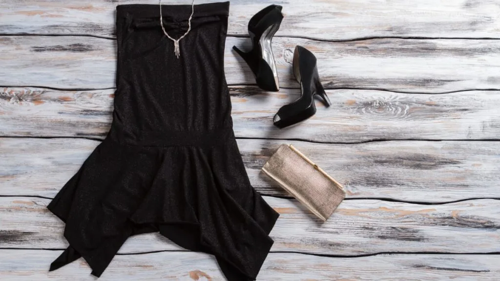 robe noire, bijoux et escarpins pour une tenue de fêtes élégante