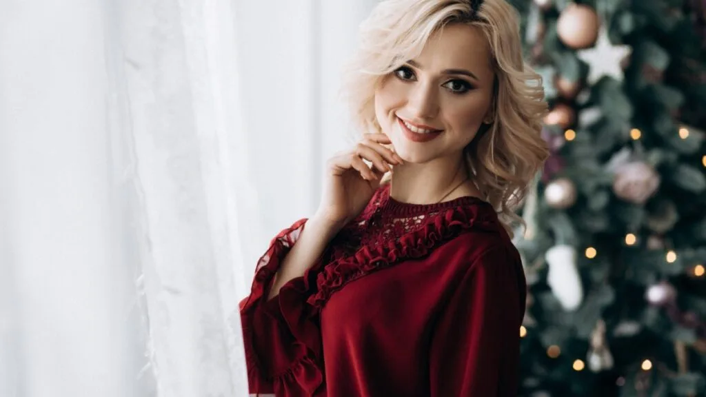 Femme portant une robe en velours bordeaux pour une tenue de Noël élégante et confortable
